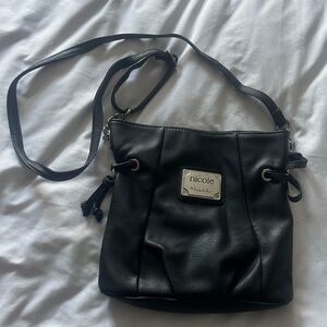 Nicole by Nicole Miller crossbody black purse.  Good condition.  Purple lining.
